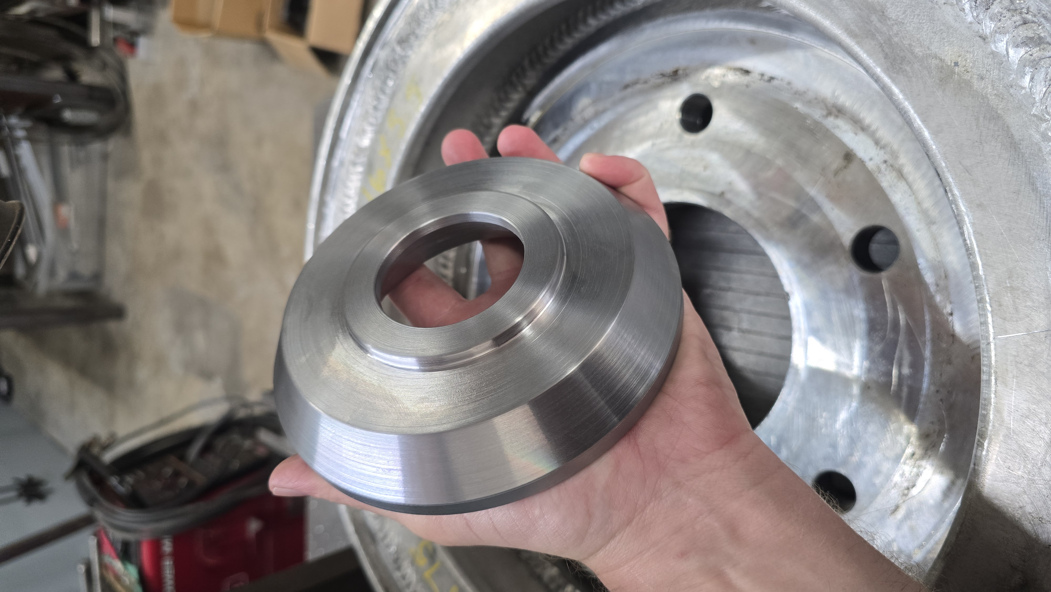 Finished machined flange held at the JDA bench
